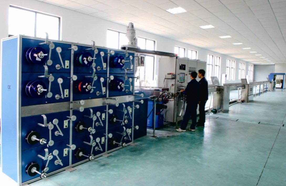 Fiber optic cable technician checking production equipment